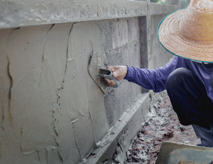  mason rural thailand Plastering concrete to build wall background industrial worker with...