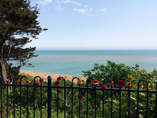 Memorial poppy railings above beach in Folkstone, Kent, UK