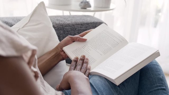 Solitary woman reading a book at home