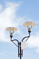 Lamppost on a cloudy sky background