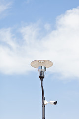 Lamppost on a cloudy sky background