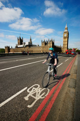 Fast moving London bicycle commuter crossing Westminster Bridge.