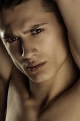 Muscle strong beautiful stripped male model portrait on black isolated font background