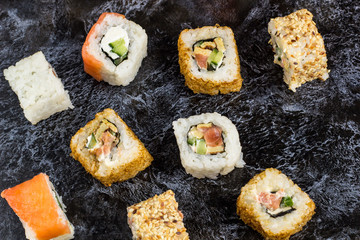 Set of sushi and maki on stone table. Top view