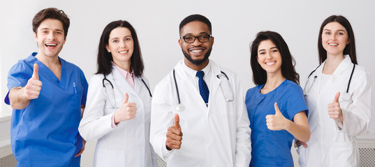 Happy Doctors And Interns Showing Thumbs Up