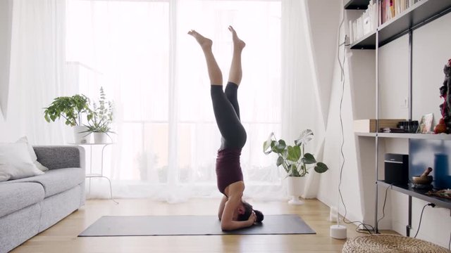 Solitary woman exercising in living room