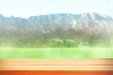 Wood table top on blur mountains background. Nature concept of landscape. Empty brown wooden table on natural background for montage product display or design key visual layout.