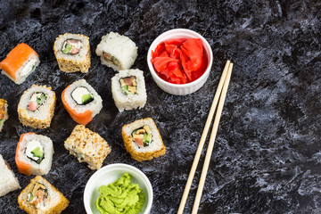 Set of sushi and maki on stone table. Top view with copy space