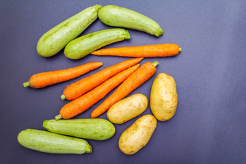 Fresh vegetables cooking black stone background