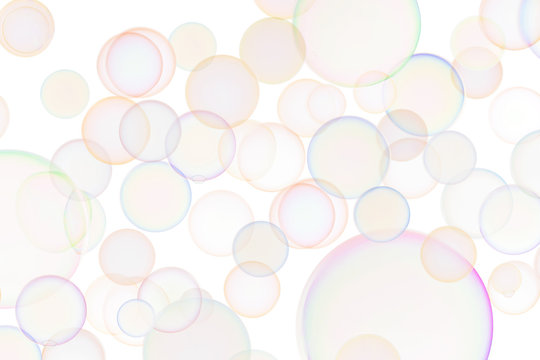 Background of flying transparent soap bubbles with rainbow reflection