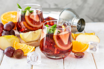 Sangria and ingredients in glasses on wood background, copy space