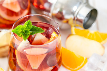 Sangria and ingredients in glasses on wood background, copy space