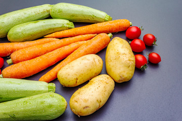 Fresh vegetables cooking black stone background