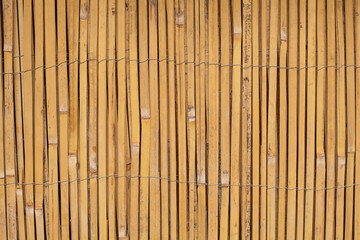 Vintage Wooden bamboo Background. Thin cane bamboo tied together with wire background