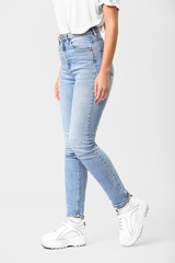 Naklejka premium Beautiful young woman in jeans on white background