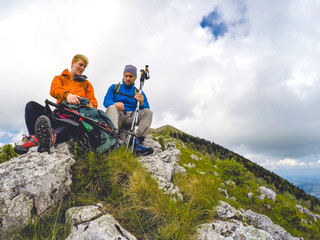Two hikers sitting on the top of the Mountain