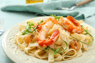 Tasty shrimps and pasta on plate, closeup
