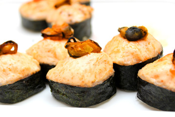 Hot rolls with cheese and mussels on a white surface
