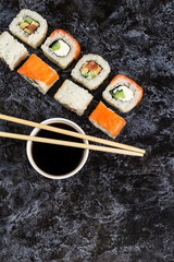 Set of sushi and maki on stone table. Top view with copy space