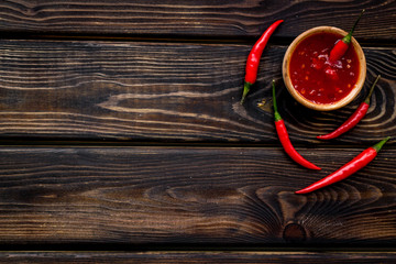 Fresh red chilli pepper pattern on wooden table background top view space for text