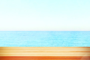Fototapeta premium Table top with beach background, sky and cloud in sunny day for product display job showing. Wooden table for display or montage your products.