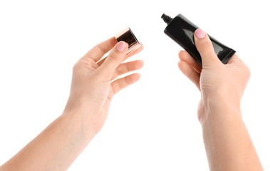 Female hands with tonal foundation on white background