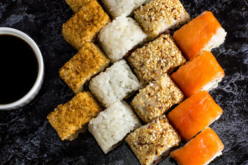 Set of sushi and maki on stone table. Top view with copy space