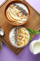 Bowls with tasty chia dessert on wooden board