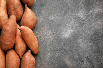 Raw sweet potato on grunge background