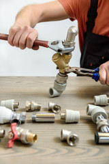 A worker is connecting elements of the plumbing.