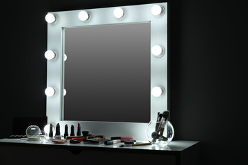 Table with cosmetics and mirror in modern makeup room