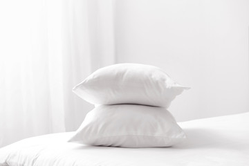 Fototapeta na wymiar Soft pillows on cozy bed