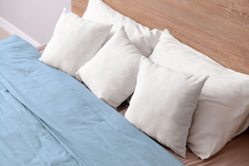 Fototapeta na wymiar Cozy bed with soft pillows