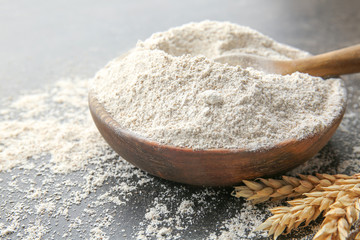 Plate with flour on grey background