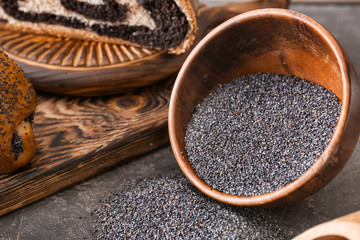 Bowl with poppy seeds on table