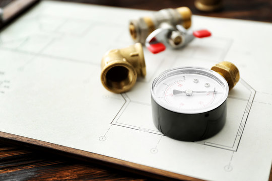 House plan with plumbing items on table, closeup