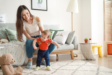 Happy mother with adorable baby boy at home