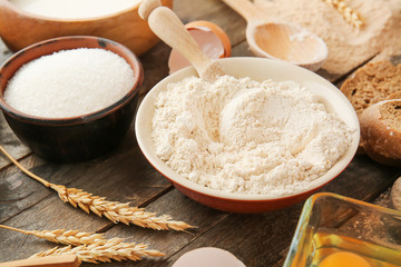 Flour with products on wooden table