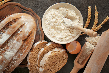 Flour with bread on dark background