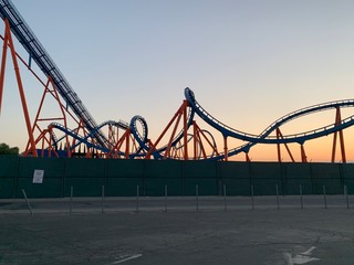 Fototapeta na wymiar roller coaster silhouetted against sunset 