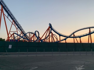 roller coaster silhouetted against sunset 