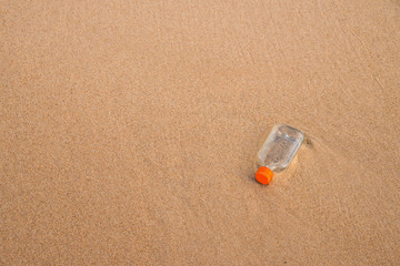 liquor bottle on a beach