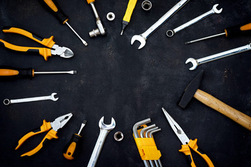 construction tools in wooden box in black background