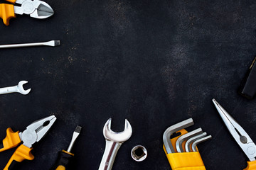 construction tools in wooden box in black background