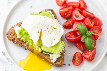Sandwich with cheese cream, salad and poached egg. Healthy food