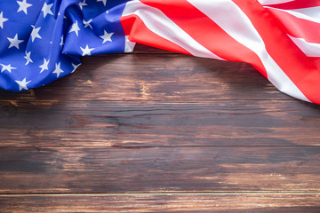 American flag on a wooden table background. Space for text