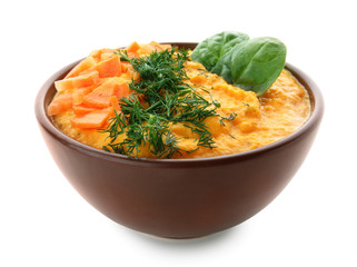 Bowl of tasty carrot cream soup on white background
