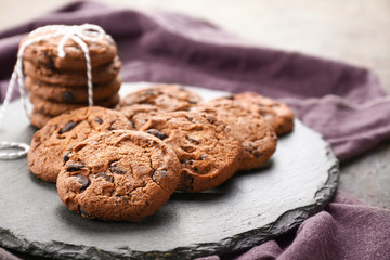 Tasty chocolate cookies on slate plate