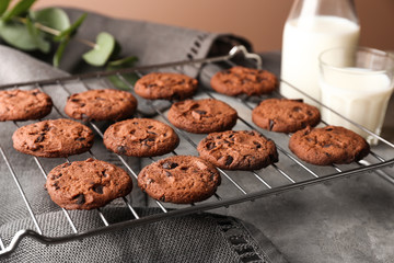 Tasty chocolate cookies on cooling rack