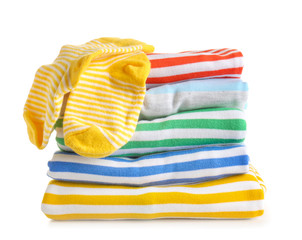 Stack of baby clothes on white background